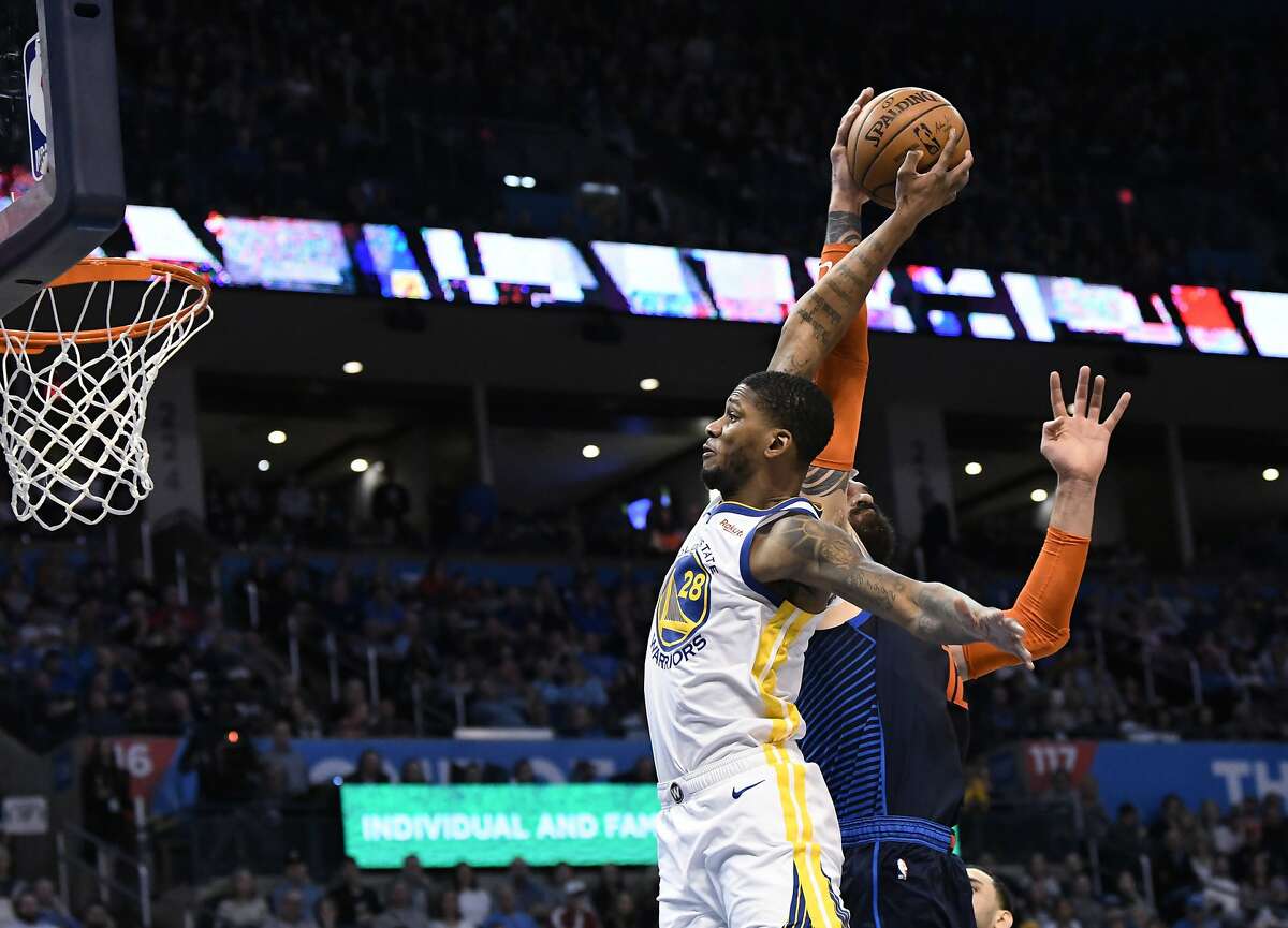 Oklahoma City Thunder center Steven Adams (12) blocks a shot by Golden State Warriors forward Alfonzo McKinnie (28) during the first half of an NBA basketball game Saturday, March 16, 2019, in Oklahoma City. (AP Photo/June Frantz Hunt)