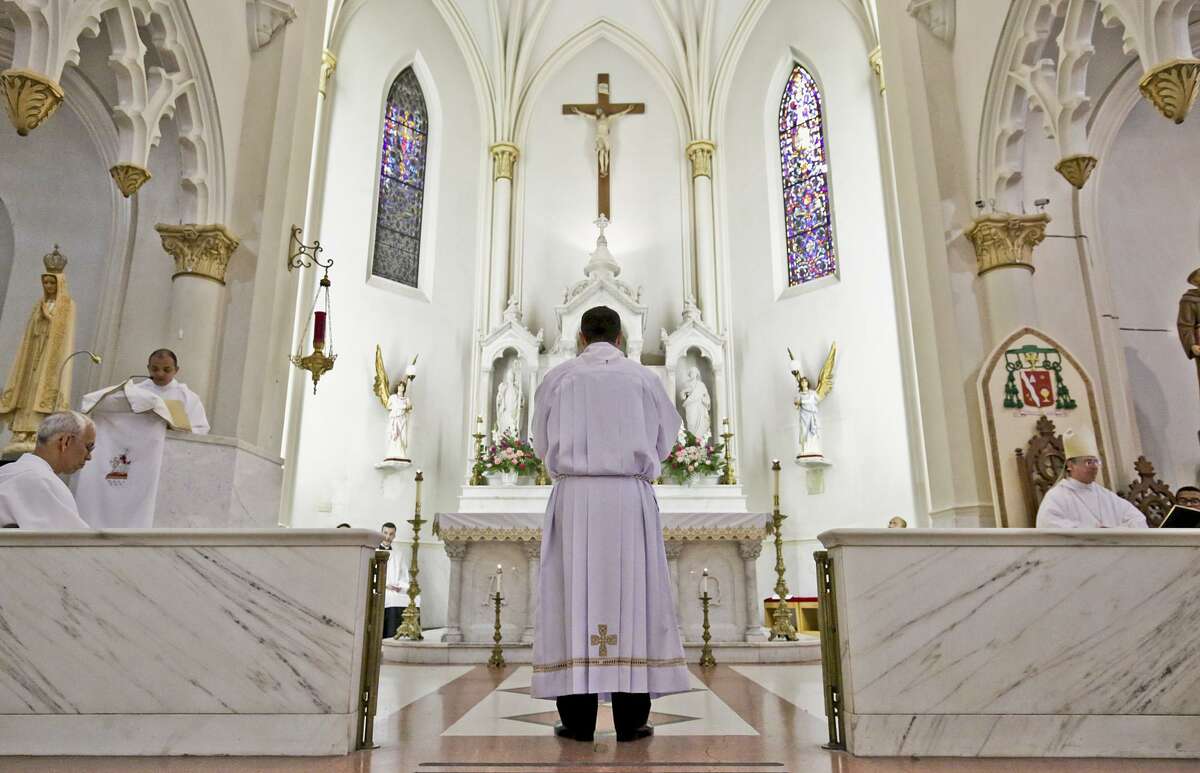 Jose Guadalupe Cadena stands before the altar Saturday morning at San Agustin Catholic Cathedral.