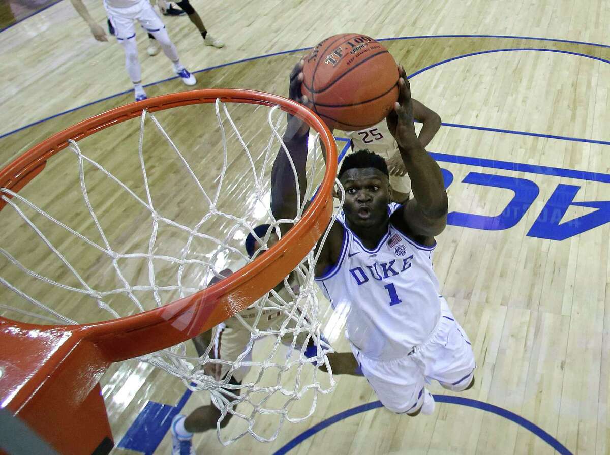 Duke's Zion Williamson (1) goes up to dunk against Florida State during the first half of the NCAA college basketball championship game of the Atlantic Coast Conference tournament in Charlotte, N.C., Saturday, March 16, 2019. (AP Photo/Chuck Burton)