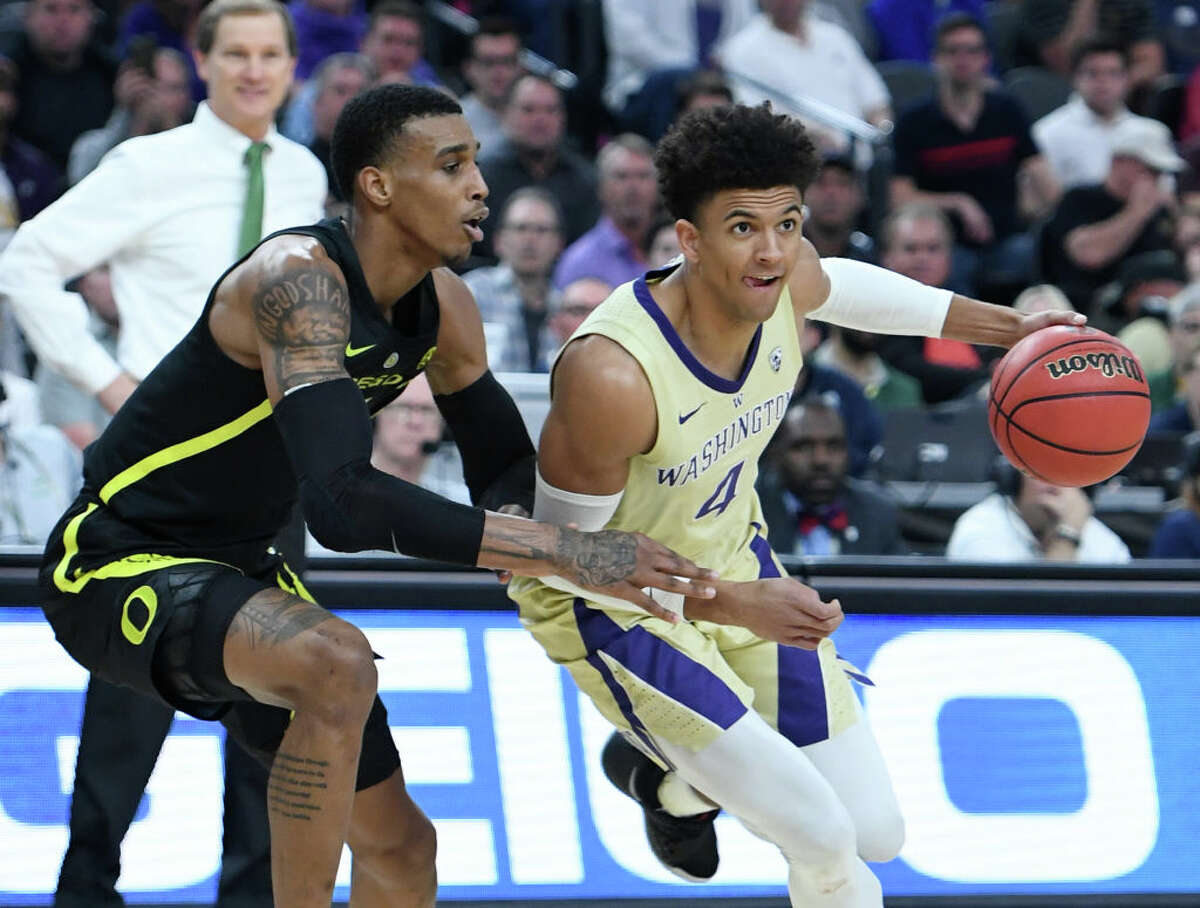Matisse Thybulle #4 of the Washington Huskies drives against Kenny Wooten #14 of the Oregon Ducks during the championship game of the Pac-12 basketball tournament at T-Mobile Arena on March 16, 2019 in Las Vegas, Nevada.