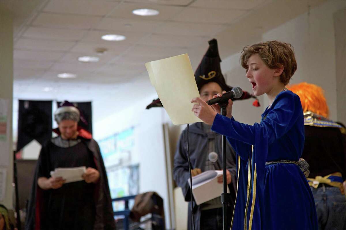 Alex Sheinkin, 11, of Bedford, N.Y., reads her part at the Purim party hosted by the Congregation for Humanistic Judaism at Bedford Middle School on Sunday, March 17, 2019, in Westport, Conn.
