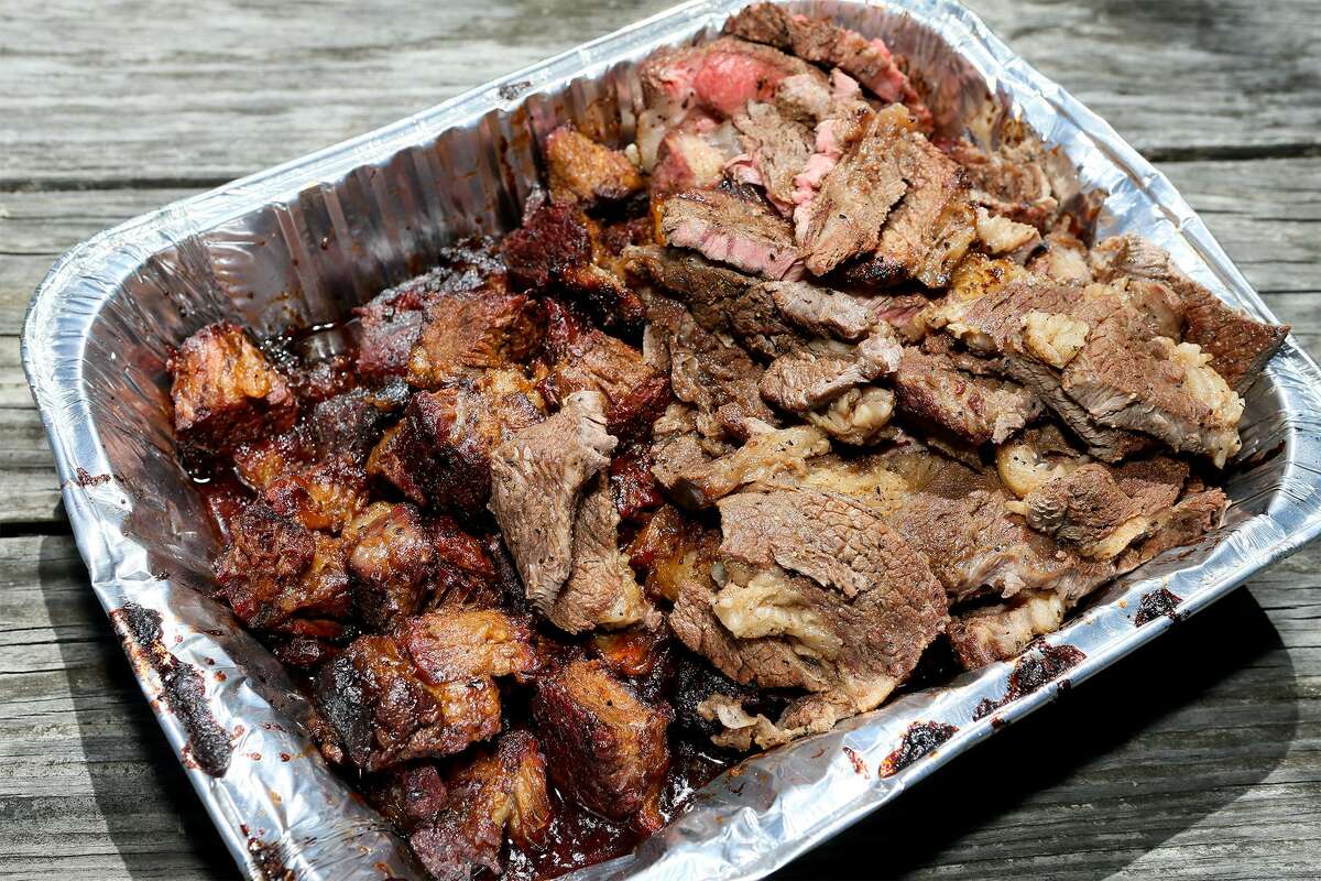 A tray of “Poor Man's Burnt Ends,” left, made from smoked chuck roast cubed into 1-inch pieces and smoked for seven hours with salt, brisket rub and barbecue sauce, and sliced grilled chuck steaks, right, at Chuck's Food Shack.