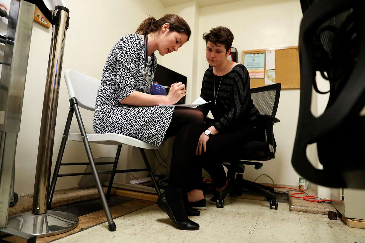 Dr. Elizabeth Imbert and social worker Jacquelyn Kelley talk about a patient that said they wanted to harm themselves during an appointment at San Francisco General Hospital's HIV/AIDS clinic in San Francisco, Calif., on Thursday, March 14, 2019.