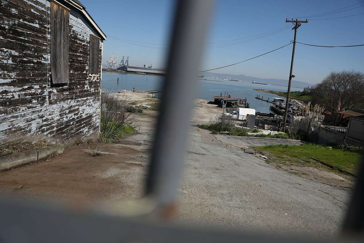 Part of the building at 900 Innes Avenue (left) and other buildings are seen behind a gate on Monday, March18, 2019 in San Francisco, Calif.