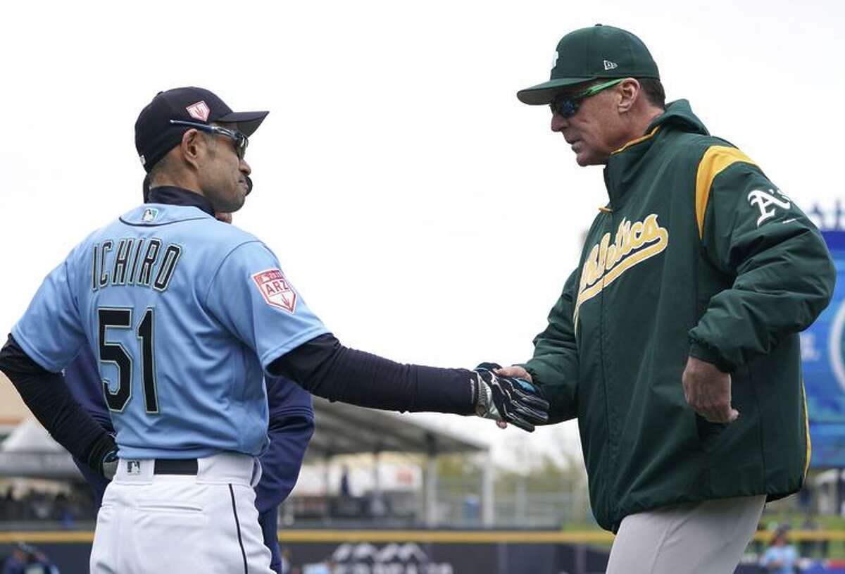 A’s manager Bob Melvin (right) faces off against the Mariners’ Ichiro Suzuki on Opening Day in Tokyo.