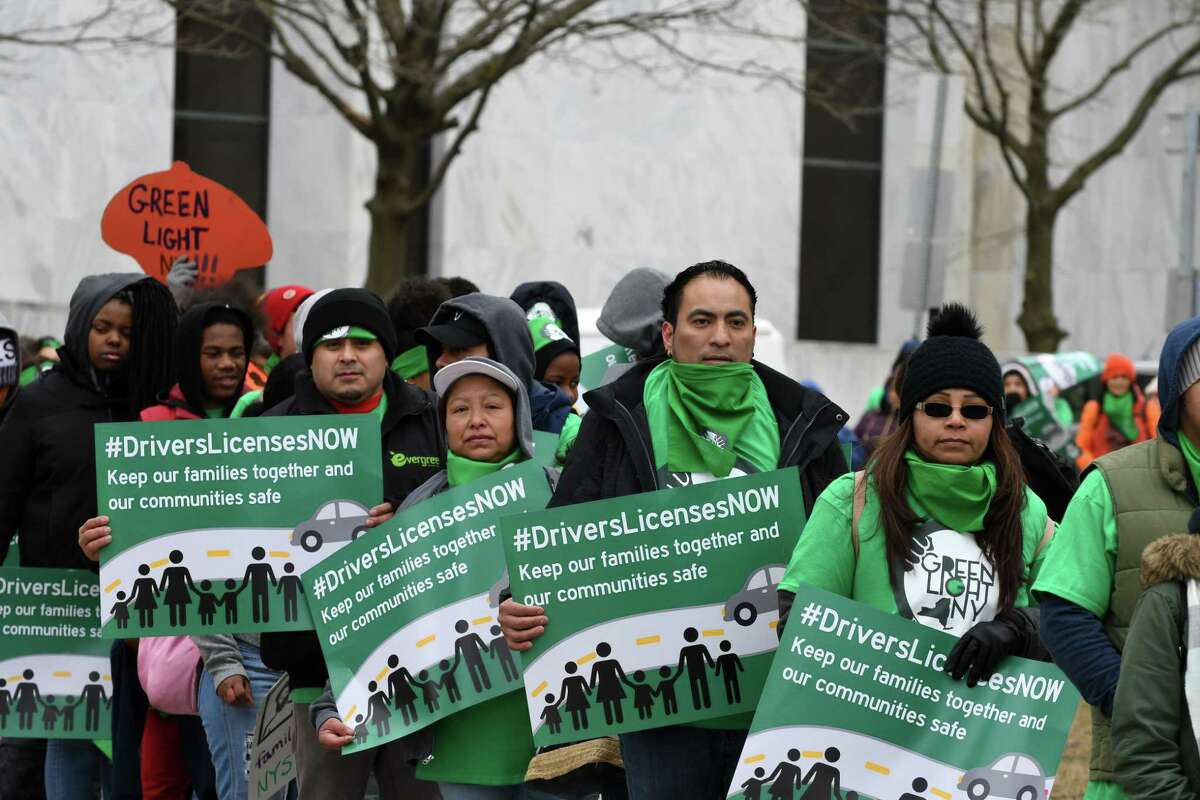 Protesters with the Green Light Campaign to get driver licenses for undocumented immigrants, march around the Capitol before holding a rally in West Capitol Park on Tuesday, March 12, 2019, in Albany, N.Y. New York currently bars immigrants from obtaining a license due to their immigration status. (Will Waldron/Times Union)