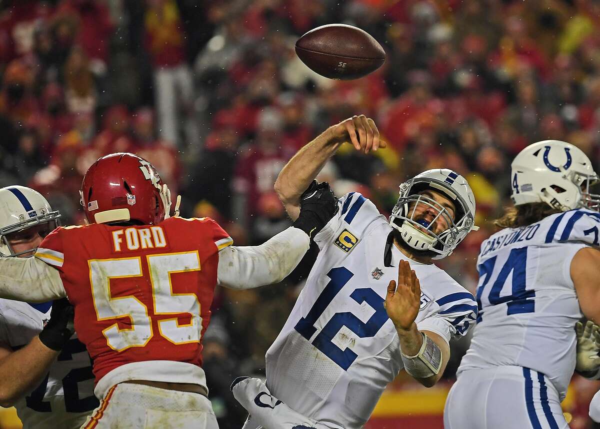 KANSAS CITY, MO - JANUARY 12: Quarterback Andrew Luck #12 of the Indianapolis Colts has the ball knocked out of his hand, attempting a pass by outside linebacker Dee Ford #55 of the Kansas City Chiefs, during the second half of the AFC Divisional Round pl