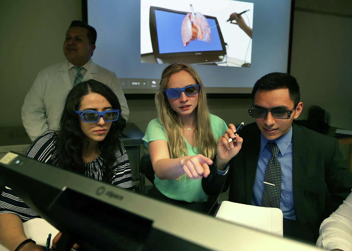UTSA students Nayely Kova, left to right, Lyndsay Millican and Michael Medina wear 3D glasses while they use the zSpace virtual reality program on March 14, 2019. UTSA held a virtual reality anatomy conference that enabled premed and predental students to virtually dissect organs.
