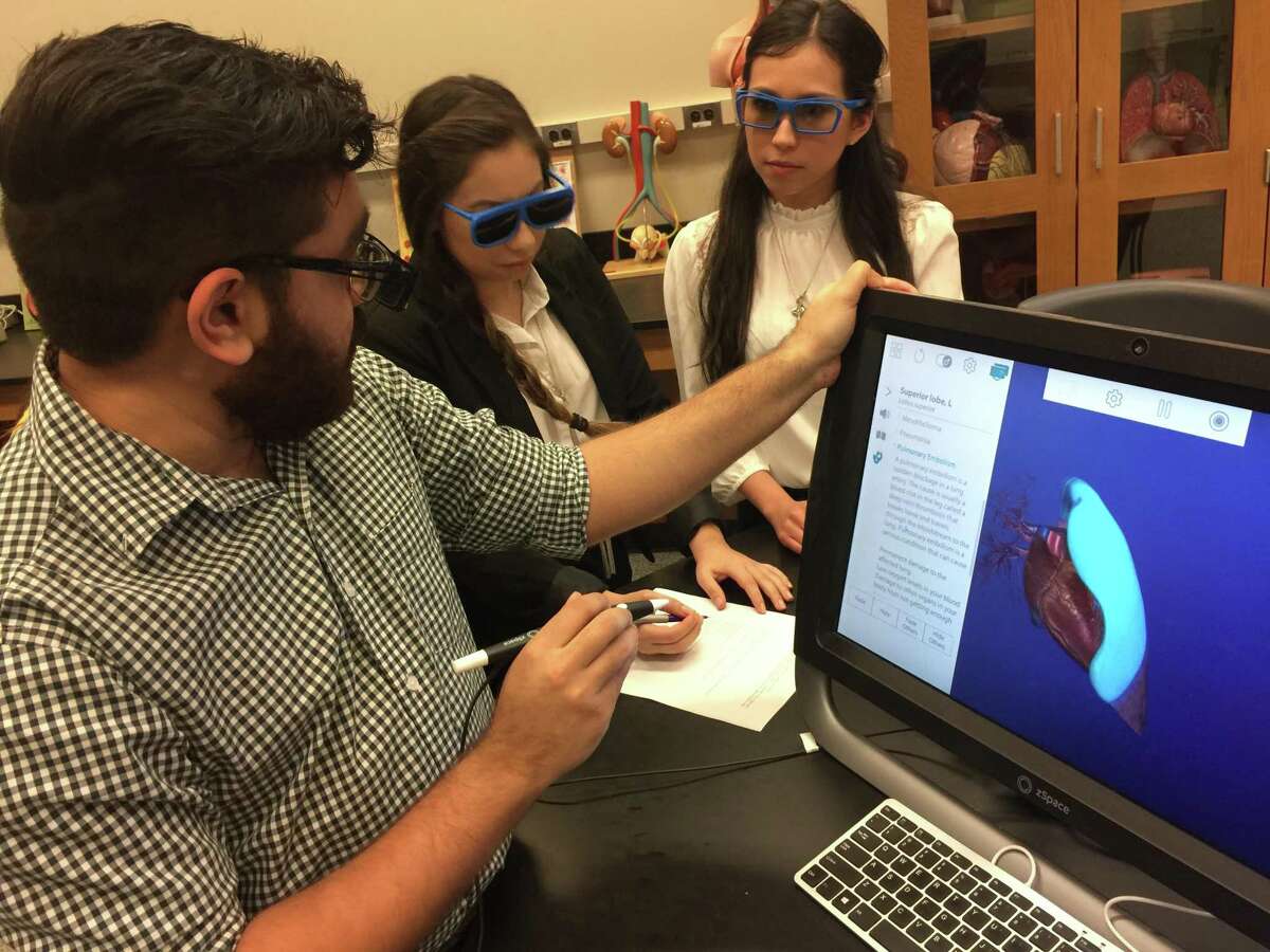 UTSA students Apurva Rawal, from left, Lindsey Gutierrez and Michelle Gamboa use the zSpace virtual reality program to look at an image. Premed and predental students dissected organs using 3D technology.