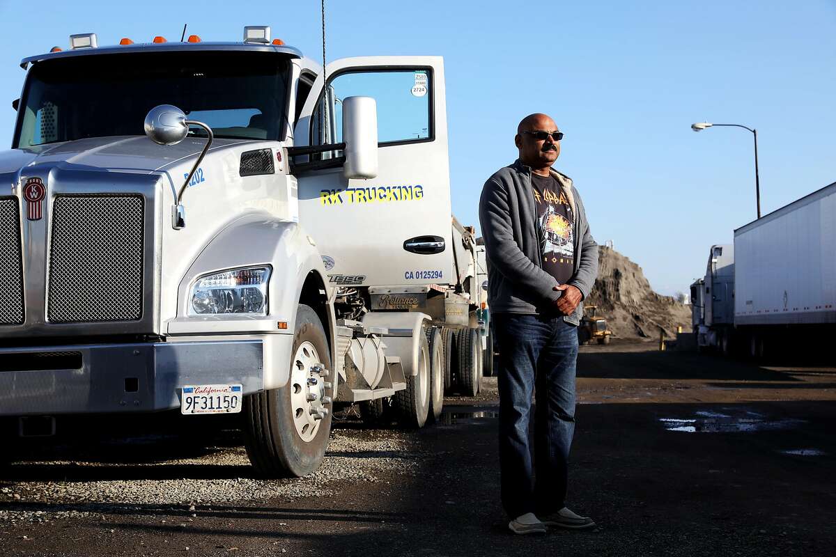 Ravinder Singh poses for a portrait with his truck in Newark, Calif., on Thursday, January 31, 2019. A possible new California law would make more independent contractors become employees. Singh has been an independent truck owner-operator since the late 1990s, and prefers to stay an independent contractor, not an employee.