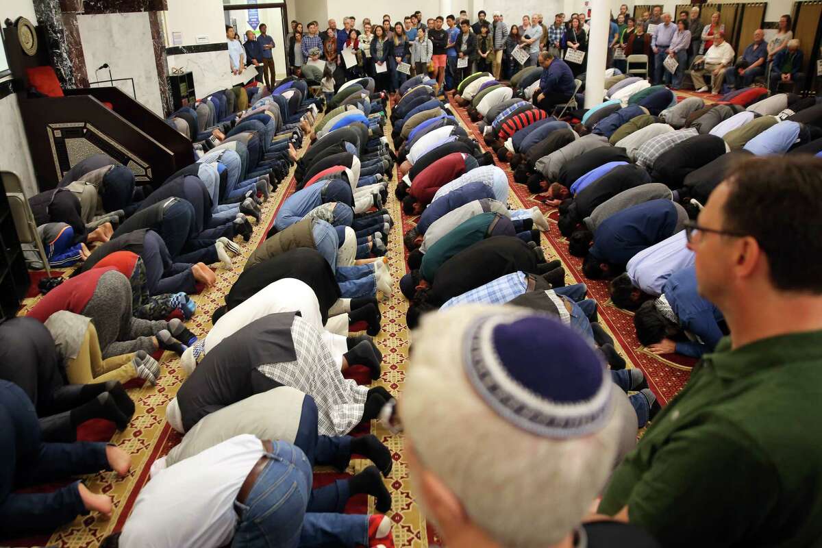 People pray as hundreds attend an interfaith vigil and anti-islamophobia teach-in at the Muslim Association of Puget Sound, held in response to last week's mass-shooting in Christchurch, New Zealand, Monday, March 18, 2019.