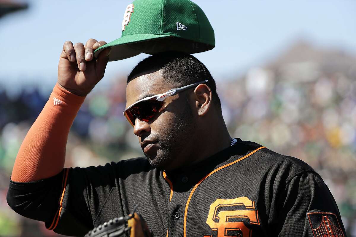 San Francisco Giants' Pablo Sandoval pulls off his cap as he heads into the dugout during a spring training baseball game Sunday, March 17, 2019, in Scottsdale, Ariz. (AP Photo/Elaine Thompson)