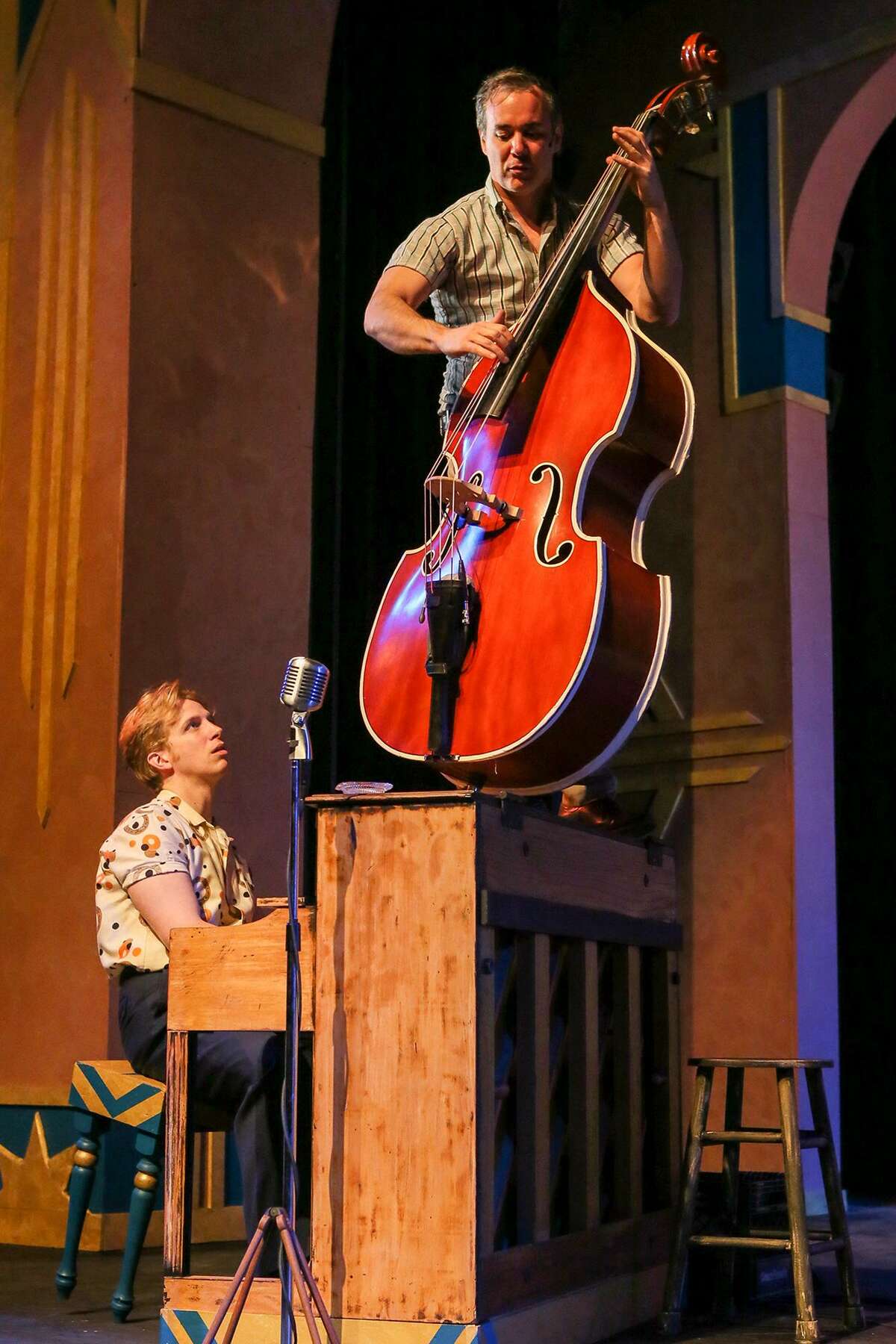 Nathan Yates, top, portraying Carl Perkins' brother, Jay, plays bass on top of the piano played by Gavin Rohrer, portraying Jerry Lee Lewis, during a rehearsal for the musical "Million Dollar Quartet" at The Public Theater on Sunday, March 17, 2019.
