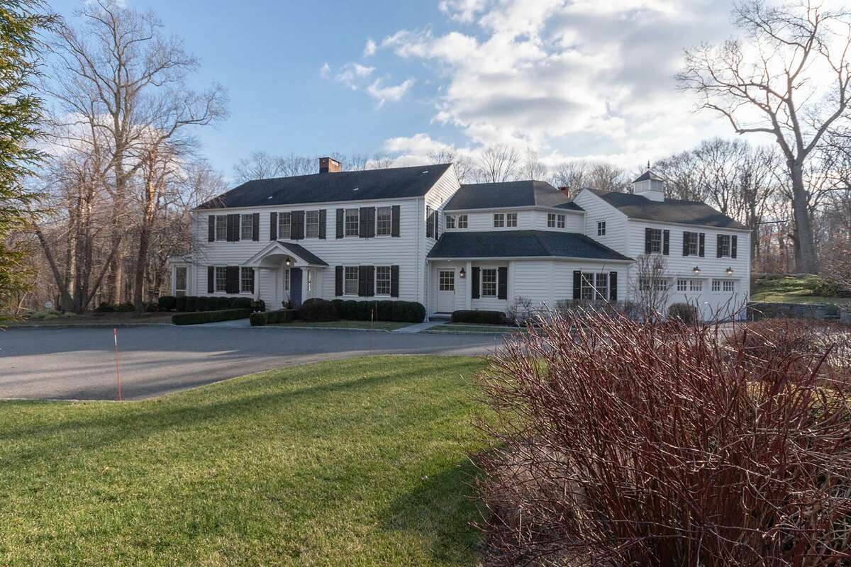 The six-bedroom center-hall colonial at 75 Deforest Road in Wilton is on a professionally landscaped 2.76-acre lot that backs up to conservation land.