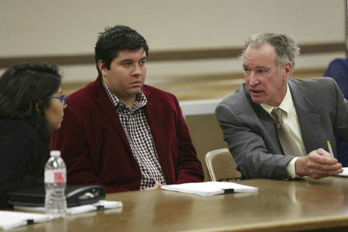 Attorney Phil Ross, right, talks with his clients, Brittany Martinez Thrash, 25, and her brother, Joe Martinez Thrash, 27, during an adoption hearing before Bexar County 73rd District Court Judge David Canales, Tuesday, March 19, 2019. The guardians of incapacitated Charlie Thrash, 81, took the siblings to court to have the adoptions by the elder Thrash nullified. Their mother married Thrush in five-minute ceremony on March 4th and the next day he adopted her adult children. Last Friday, Judge Oscar Kazen annulled the marriage. During the adoption hearing, Canales ruled in favor of the guardians and nullified the adoptions.