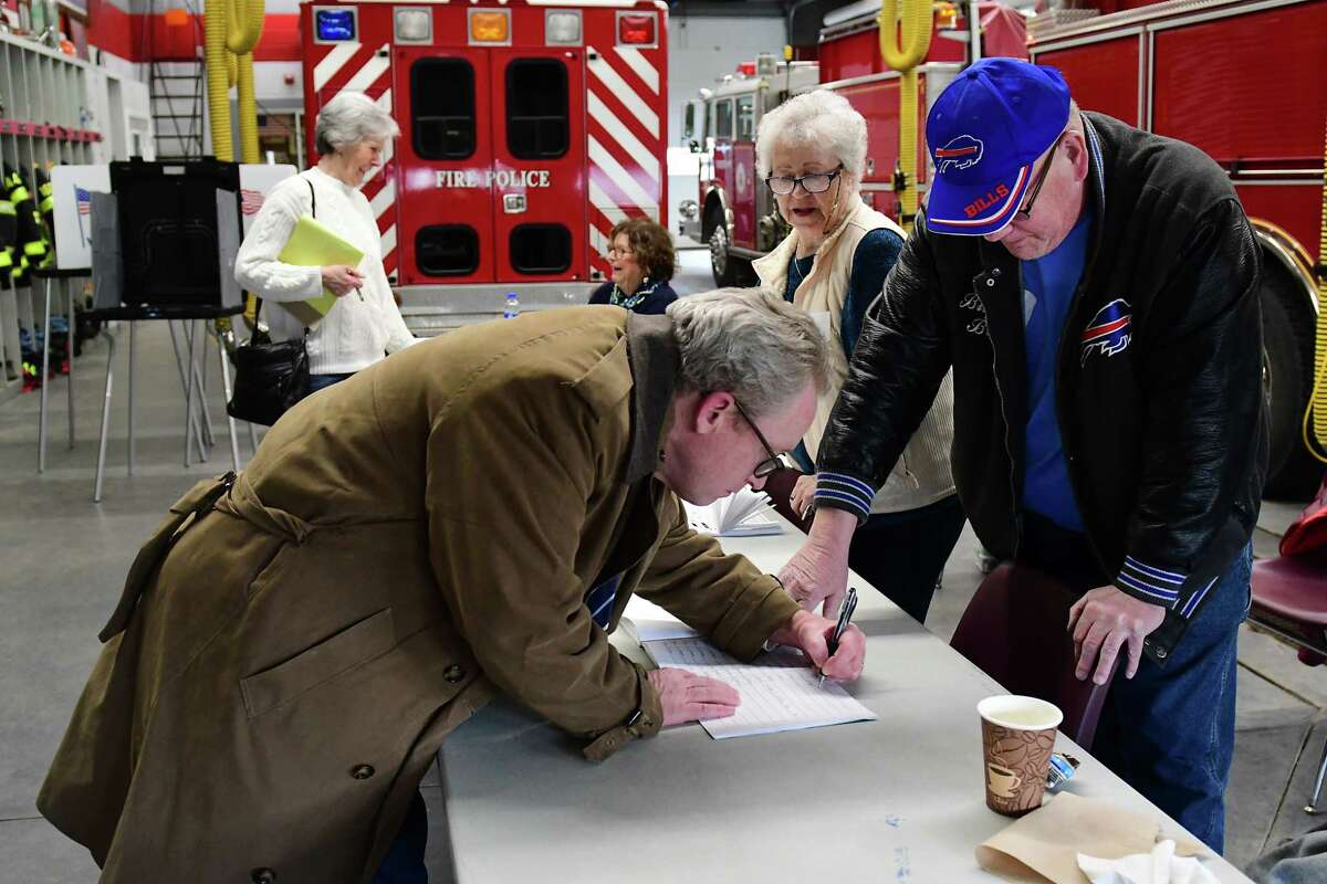 Ballston Spa resident Joseph Hogan signs in to vote with election inspectors at the Union Firehouse on a village election day Tuesday, March 19, 2019 in Ballston Spa, N.Y. Four trustees are competing for two seats. (Lori Van Buren/Times Union)