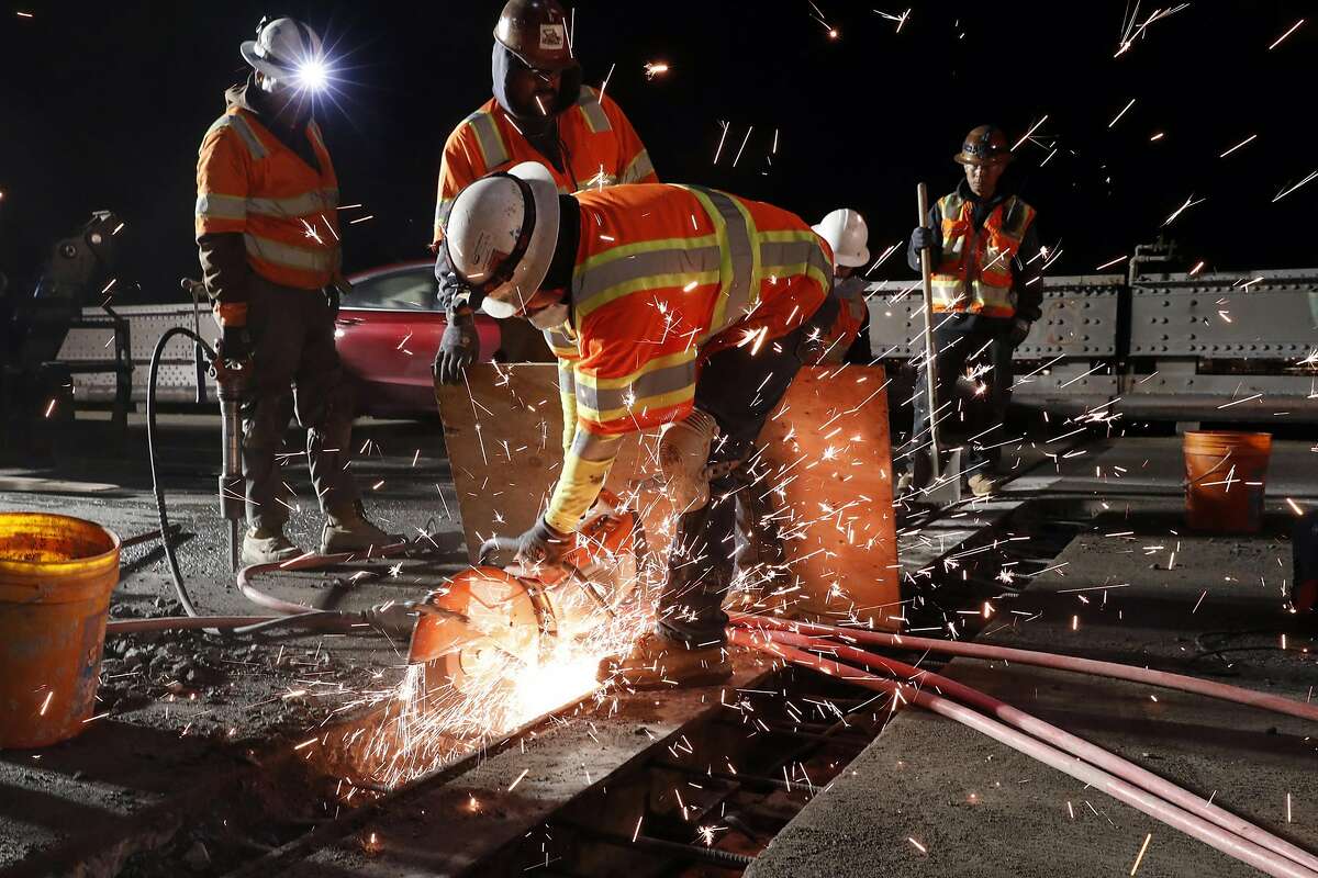Caltrans workers work on replacing an aging joint on the upper level of the Richmond-San Rafael Bridge in Richmond, Calif., on Monday, March 18, 2019.
