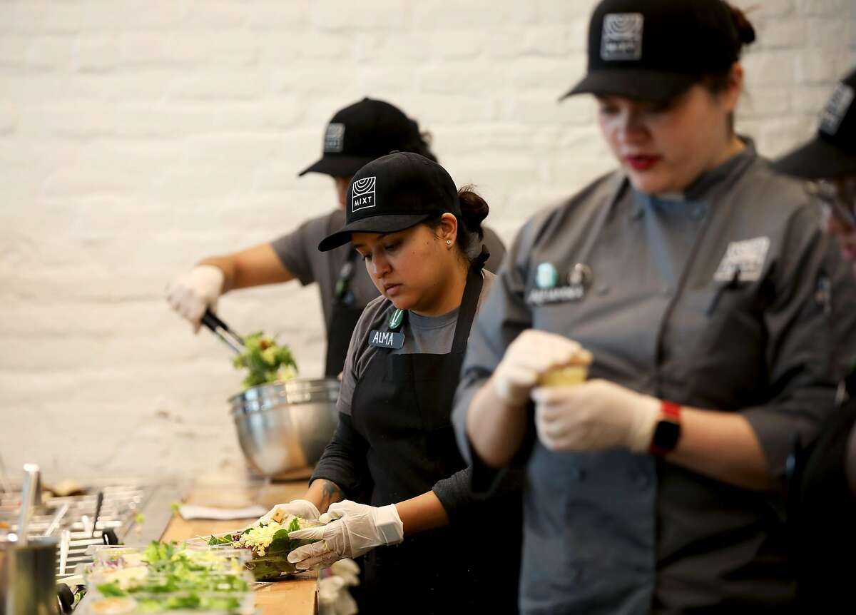 Salad chefs build salads at Mixt Greens, located at 901 Valencia St., in San Francisco, Calif., on Tuesday, March 19, 2019. The local salad chain is opening its first two new East Bay locations next month in Oakland and San Ramon. But Mixt also has national ambitions, with a Texas restaurant opening on May 18.
