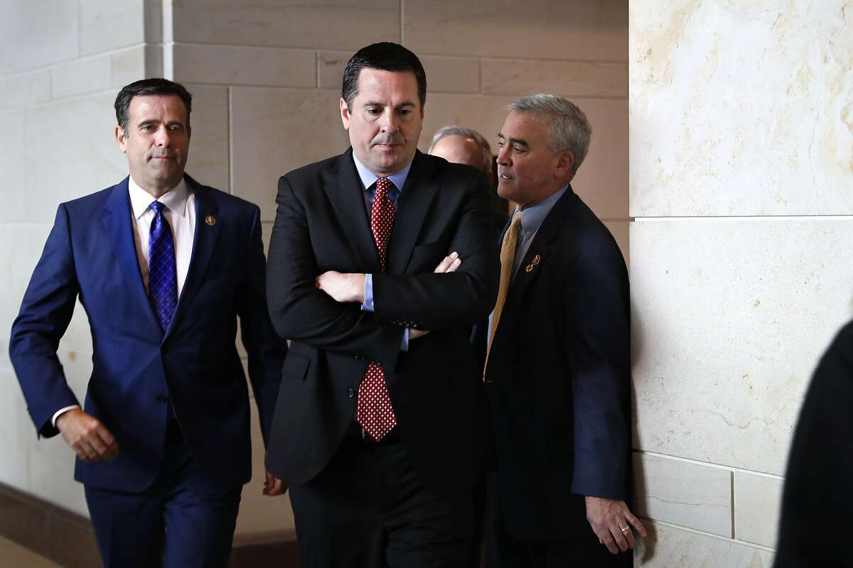 Rep. John Ratcliffe R-Texas, left, and House Intelligence Committee Ranking Member Devin Nunes, R-Calif., center, leave a closed-door meeting of the House Intelligence Committee with testimony from Michael Cohen, President Donald Trump's former personal lawyer, Monday, Feb. 5, 2018, to attend a vote on Capitol Hill in Washington. (AP Photo/Jacquelyn Martin)