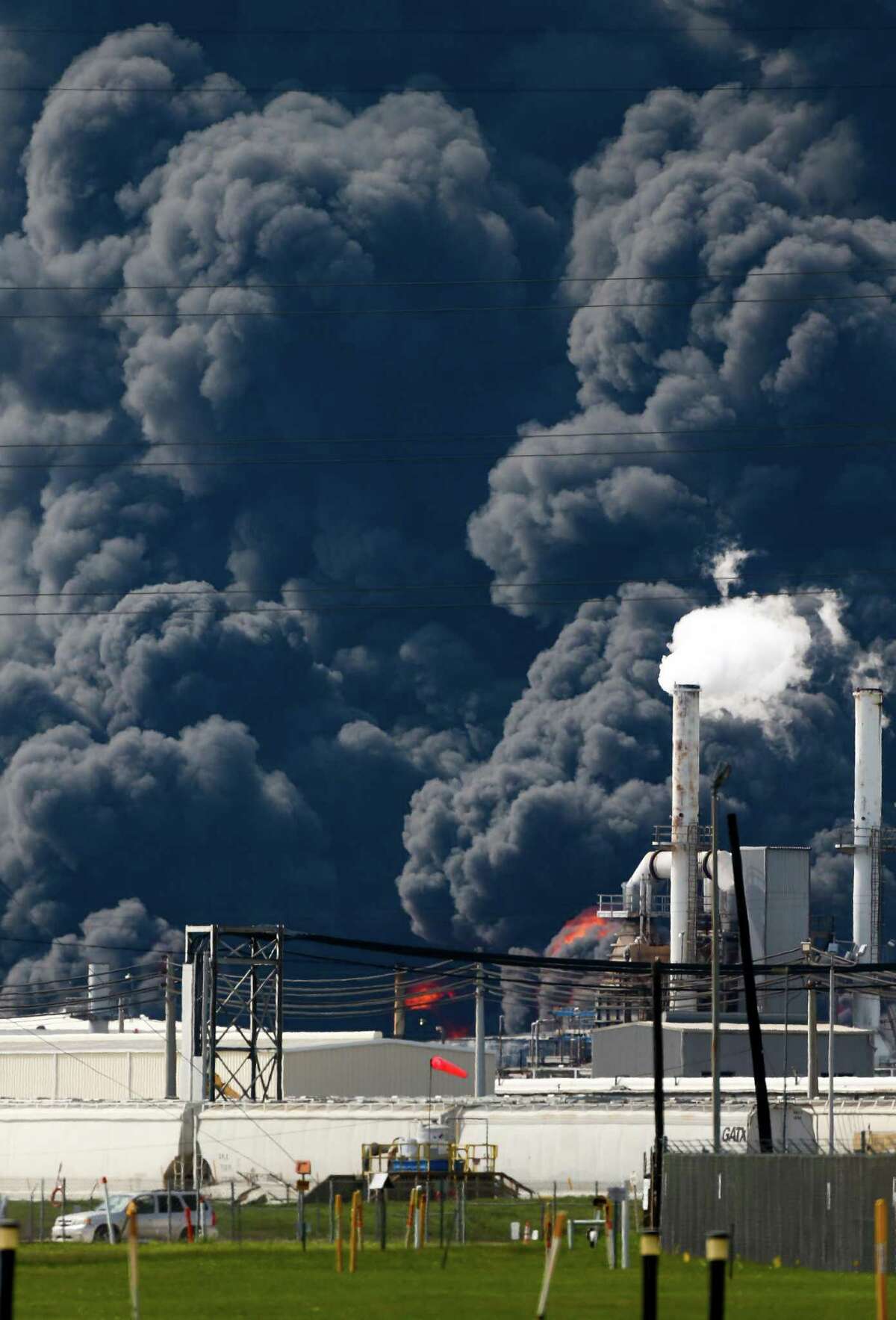 Firefighters battle the petrochemical fire at Intercontinental Terminals Company, which grew in size due to a lack of water pressure last night, Tuesday, March 19, 2019, in Deer Park, Texas.