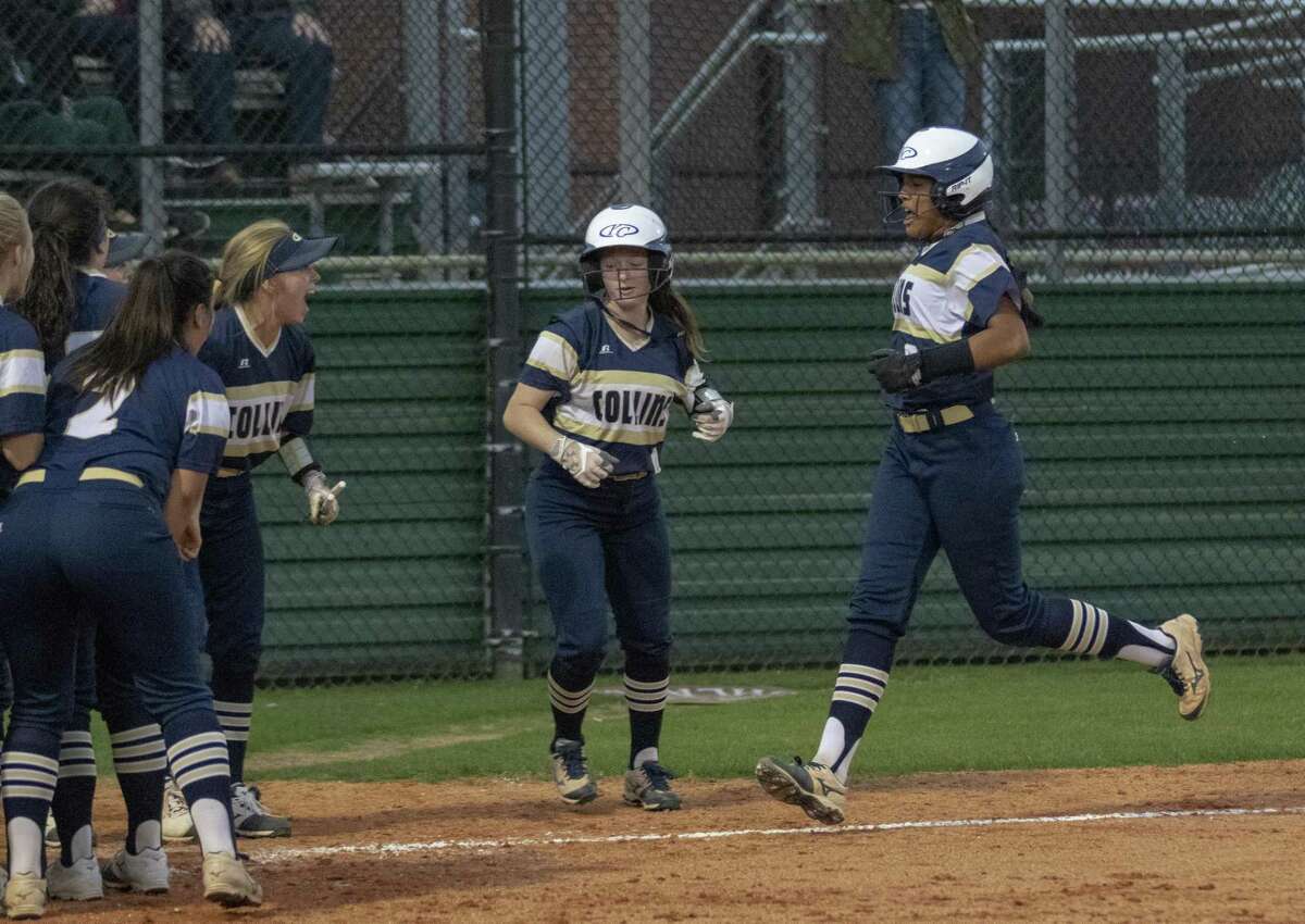 Klein Collins catcher Araya Williams (8) makes her way to home plate where her teammates are waiting after Williams hit a home run during a District 15-6A softball game Tuesday, March 19, 2019 at The Woodlands High School.