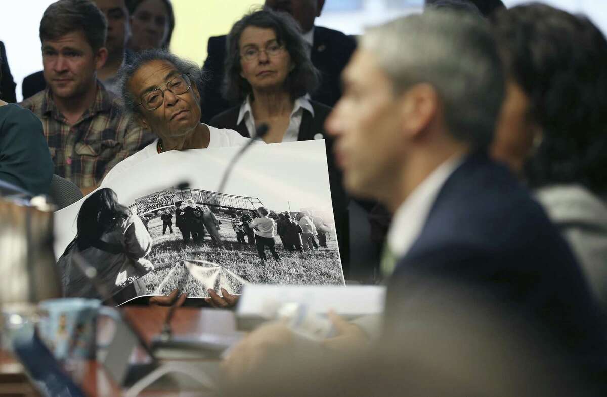 Nettie Hinton hold photograph of the Hays Street Bridge in protest during a City of San Antonio Council B-Session, Wednesday, March 20, 2019.