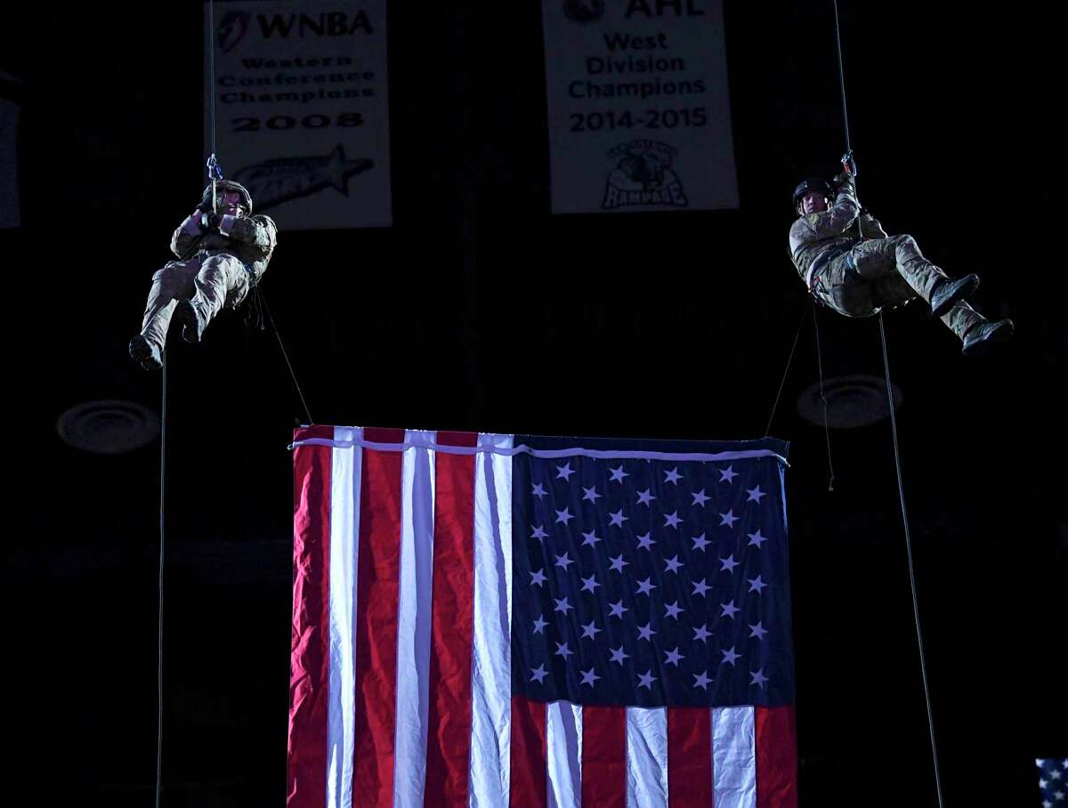 Army troopers rappel during a night to honor active duty military and veterans before the San Antonio Spurs hosted the Miami Heat in the AT&T Center last March. A series of Veterans Day events are planned this weekend and Monday.