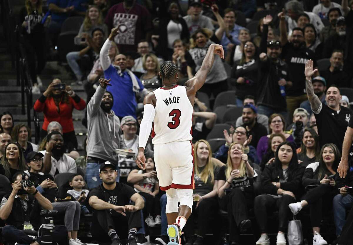Dwyane Wade celebrates his third-quarter halfcourt buzzer-beater, one of his three big plays in the second half that helped put an end to the Spurs’ nine-game winning streak.