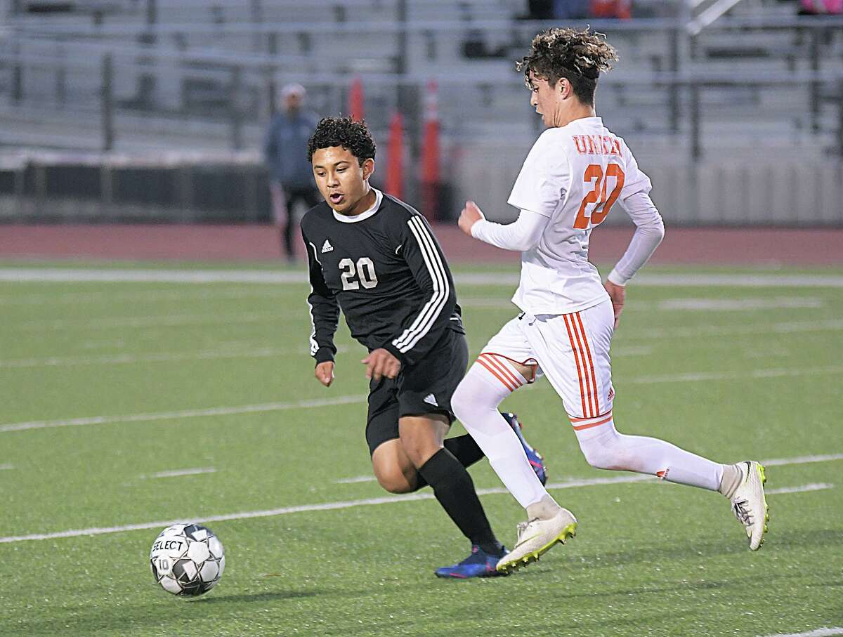 Oscar Madrid and Braulio Medina battle for the ball as the United Longhorns played the United South Panthers Wednesday, March 20, 2019 at the United ISD SAC.