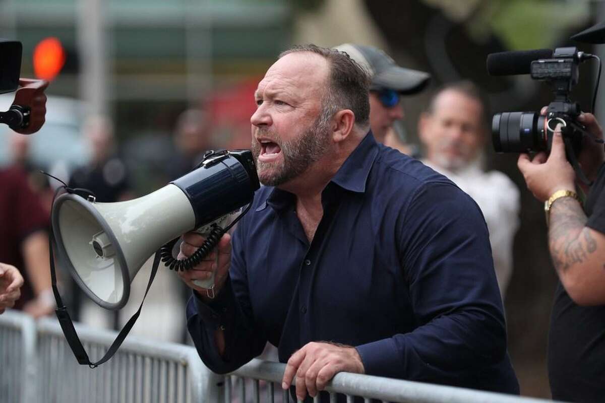 Alex Jones, of InfoWars, yells at protestors outside of Toyota Center before a Trump campaign rally, Oct. 22, 2018, in Houston.