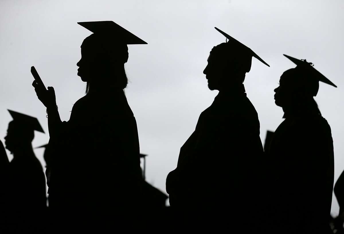 FILE- In this May 17, 2018, file photo, new graduates line up before the start of the Bergen Community College commencement at MetLife Stadium in East Rutherford, N.J. In high school, students hear that they should earn a college degree to have a well-paying, successful career. But student debt isn’t good when your degree doesn’t lead to a job that earns enough to repay it. (AP Photo/Seth Wenig, File)