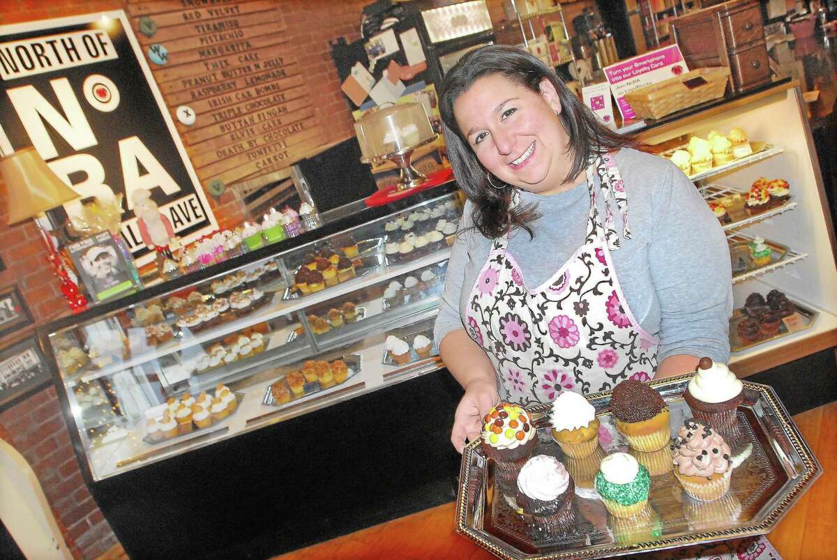 Carrie Carella, owner of NoRA Cupcake Co., 700 Main St., Middletown, displays a few customer favorites, such as the Irish Car Bomb, Adult Twinkie and Funky Monkey. Earlier this month, she opened a location in downtown New London.
