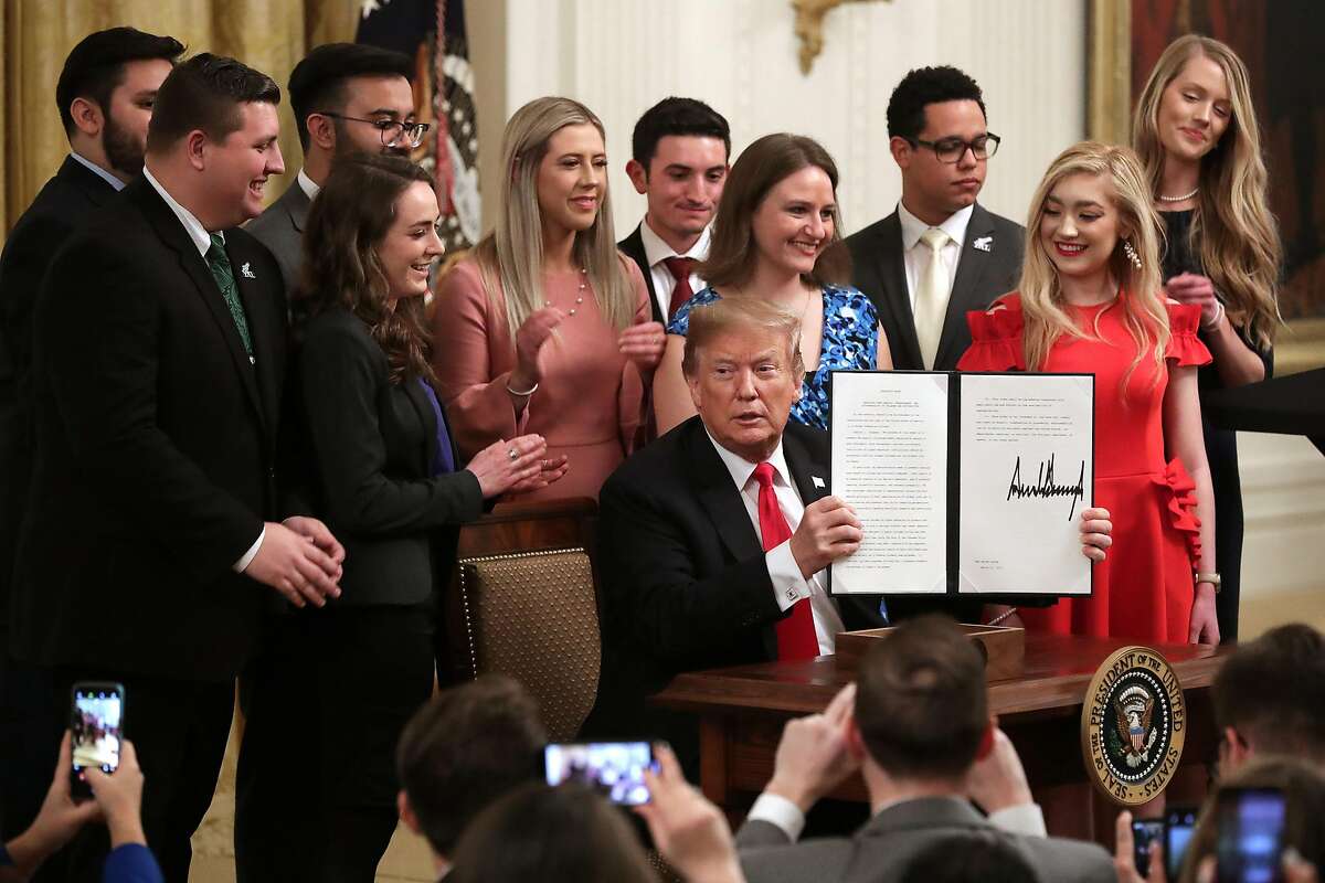 WASHINGTON, DC - MARCH 21: U.S. President Donald Trump holds up an executive order he signed protecting freedom of speech on college campuses during a ceremony in the East Room at the White House March 21, 2019 in Washington, DC. Surrounded by student who have said their conservative views are suppressed at universities across the country, Trump signed the order improving free inquiry, transparency, and accountability on campus, according to the White House. (Photo by Chip Somodevilla/Getty Images)