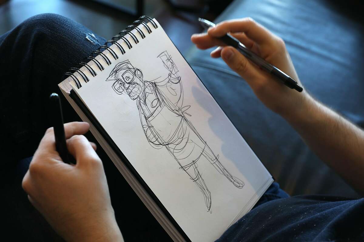 Illustrator Jeff Lance works on sketches while having coffee at Precita Park Cafe on Thursday, March 14, 2019, in San Francisco, Calif. He had an appendectomy at S.F. General trauma hospital costing him 58,000$ dollars.