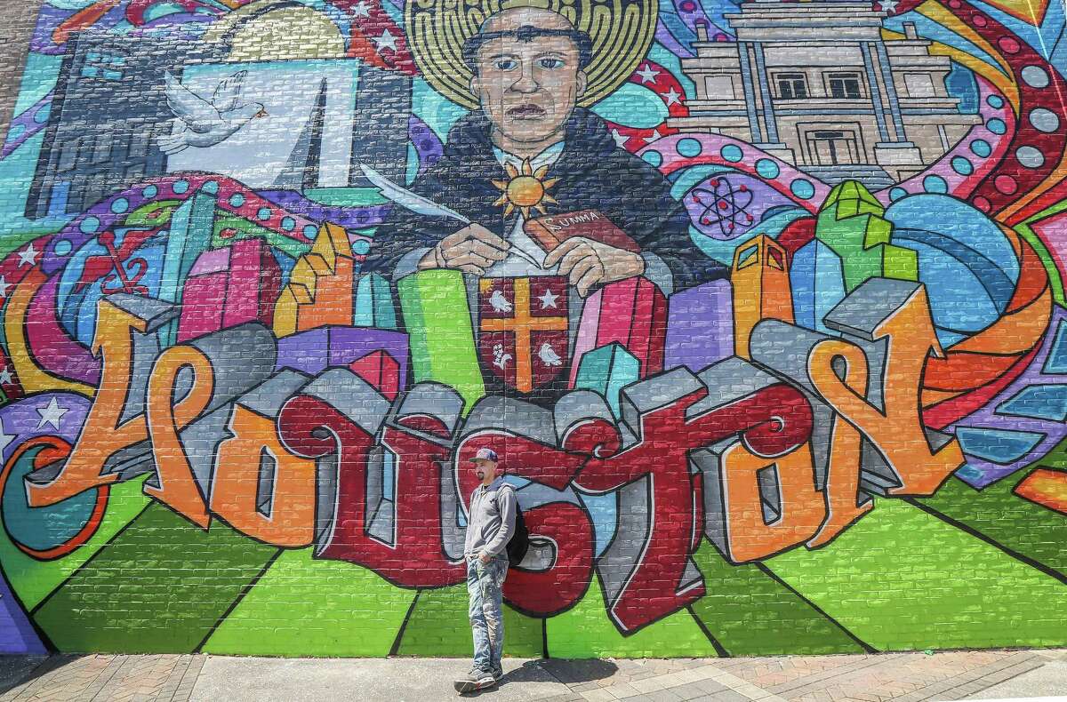 Mario Figueroa Jr., who goes by the moniker Gonzo247 poses for photos in front of his latest mural on the University of St. Thomas campus Thursday, March 21, 2019, in Houston.