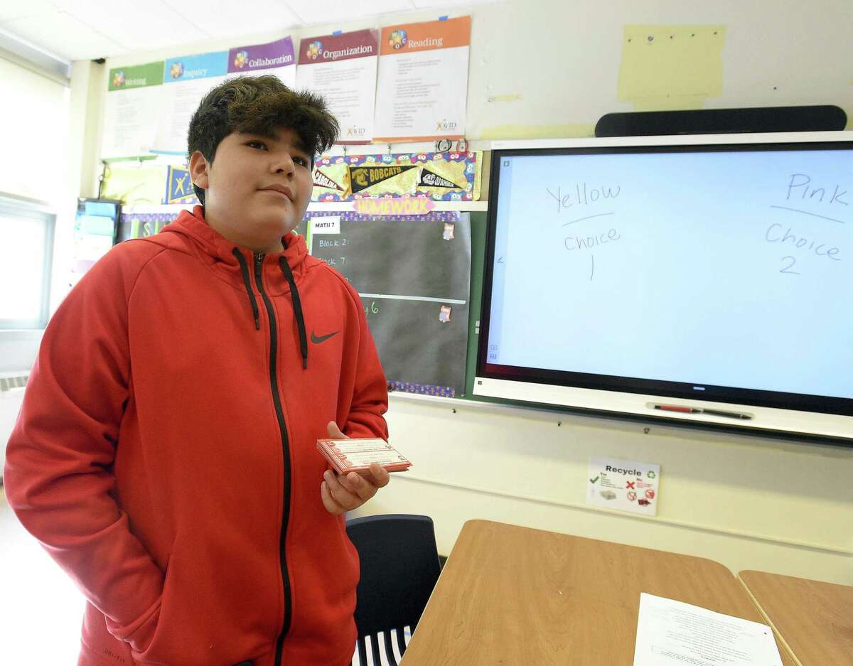 Seventh-grader William Acevedo reads aloud a question from a stack of cards as he participates in a team building classroom exercise "Would you Rather" in Alisha Barry's AVID class at Western Middle School in Greenwich, Connecticut on March 8, 2019.