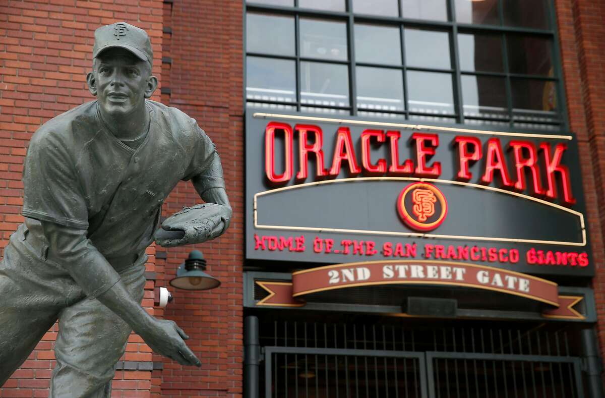 A sign behind the Gaylord Perry statue and above the 2nd Street entrance to Oracle Park is installed to reflect the name change of the Giants' home stadium in San Francisco, Calif. on Tuesday, March 19, 2019.