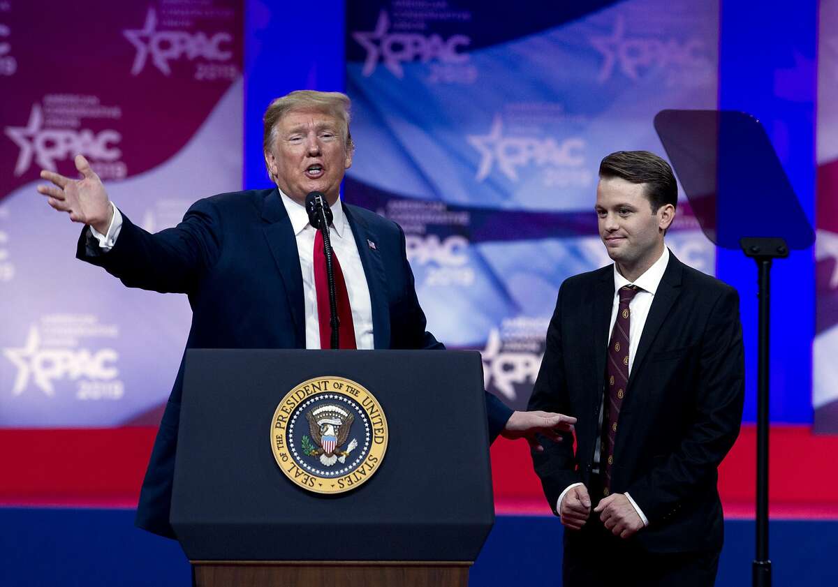 In this March 2, 2019 photo, President Donald Trump invites to the podium, Hayden Williams, a field representative of the Leadership Institute, who was assaulted at Berkeley campus, at the Conservative Political Action Conference, CPAC 2019, in Oxon Hill, Md. Trump is expected to order U.S. colleges to protect free speech on their campuses or risk losing federal funding. White House officials say Trump will sign an executive order Thursday requiring colleges to certify that their policies support free speech as a condition of receiving federal research grants. Trump initially proposed the idea during a March 2 speech to conservative activists. (AP Photo/Jose Luis Magana)