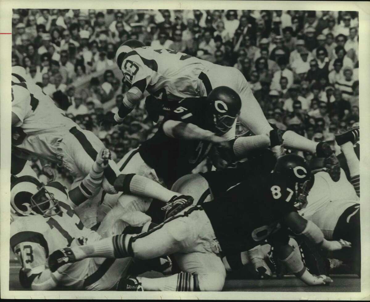 Dick Butkus of the Chicago Bears upends Los Angeles Rams' running back Willie Ellison in an NFL game. Ellison, a former Pearland substitute teacher, died March 11 and his funeral was held today at Brentwood Baptist Church.