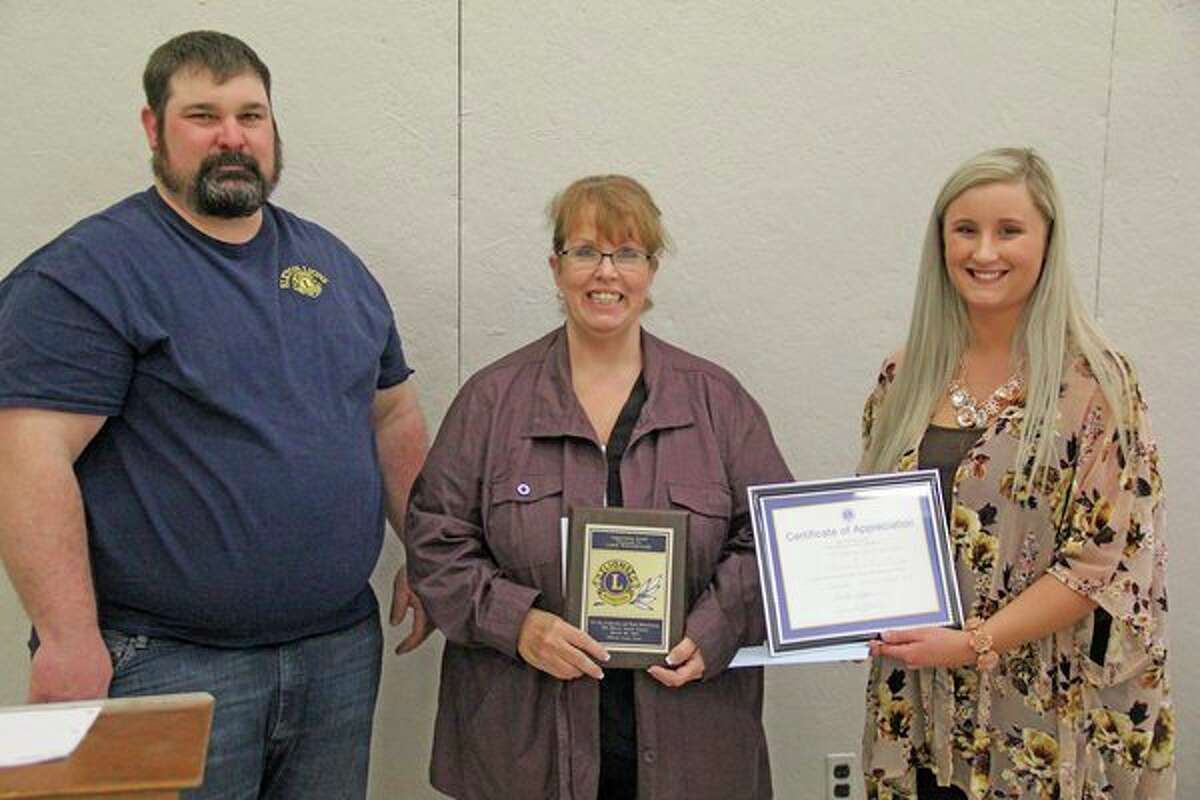 From left, Elkton Lions Club President Jason Diebel presents Jamie Wolschleger and Madison Briesmeister with certificates of appreciation for their work painting the Huron Youth Center. Wolschleger volunteered over 70 hours to the project, while Briesmeister volunteered 35 hours. (Mike Gallagher/Huron Daily Tribune)