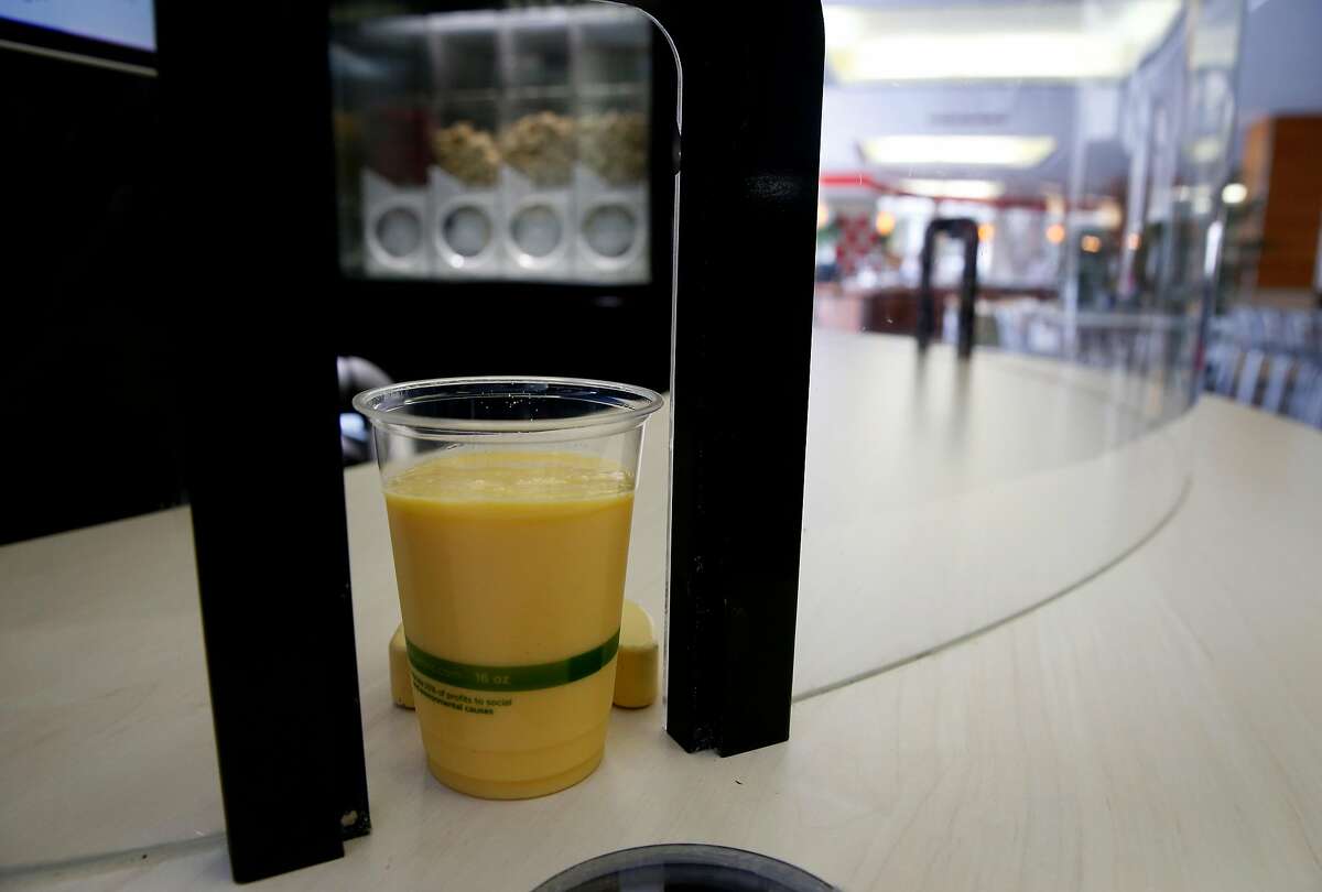 A completed order is automatically pushed towards a portal by a Blendid robotic smoothie-making kiosk during a test run at the Market Cafe on the USF campus in San Francisco, Calif. on Friday, March 22, 2019. The automated smoothie machine goes fully operational on Monday.