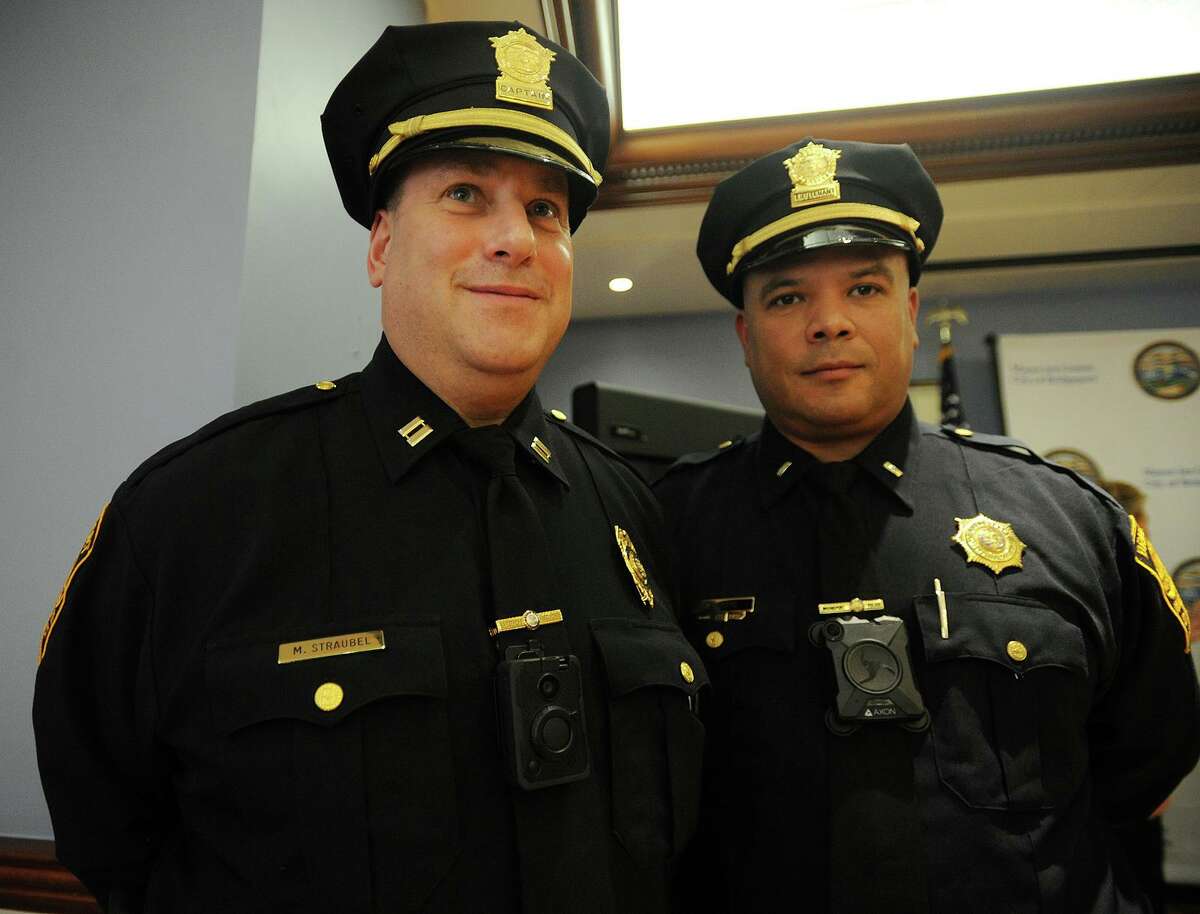 Bridgeport Police Captain Mark Straubel, left, and Lieutenant Manuel Cotto display the two types of body cameras being tested in the department's new program during the announcement at the Margaret Morton Government Center in Bridgeport, Conn. on Tuesday, February 20, 2018.