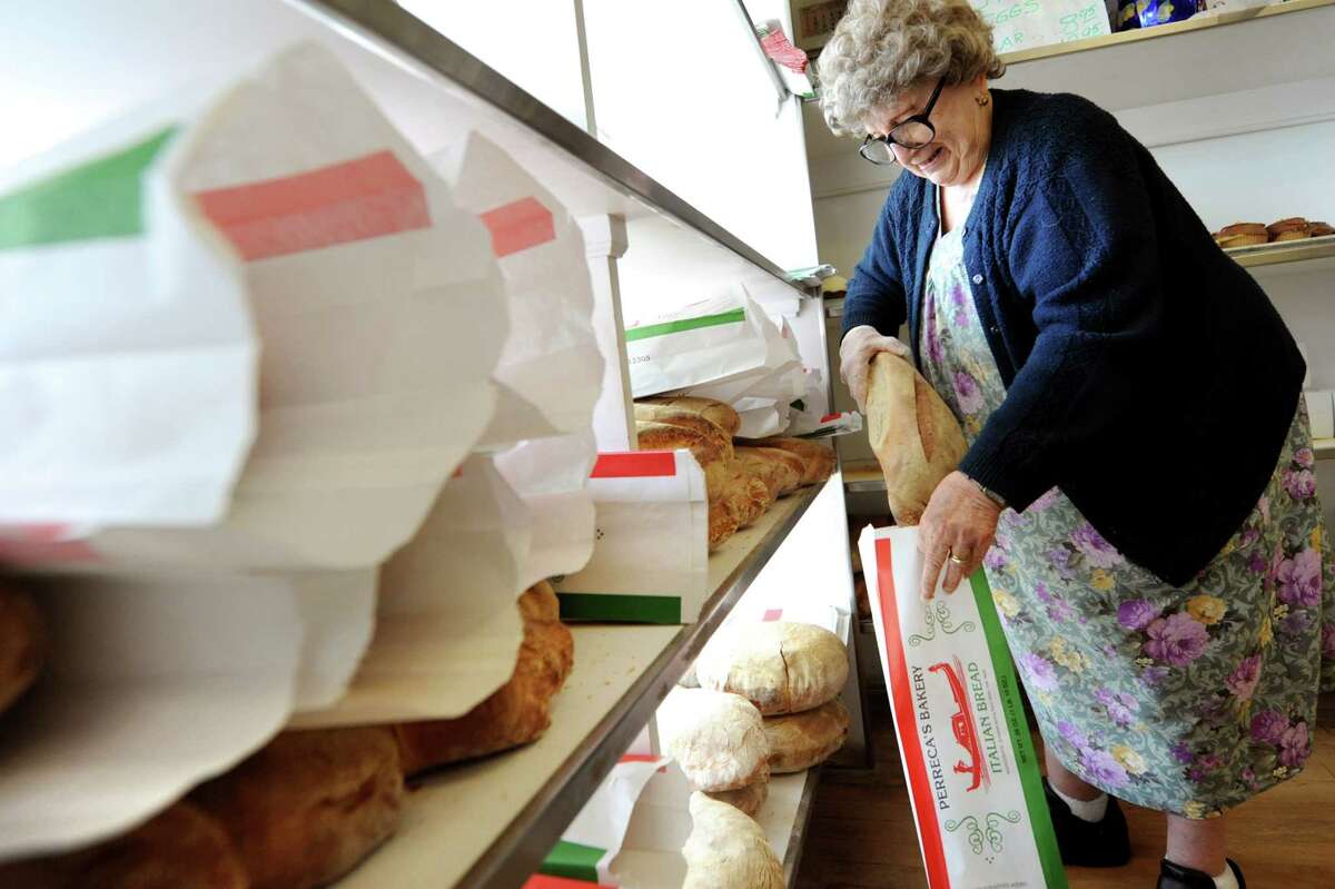 Lilia Perreca Papa, who's parents founded the business, bags fresh baked Italian bread on Tuesday, March 26, 2013, at Perreca's Bakery in Schenectady, N.Y. (Cindy Schultz / Times Union)