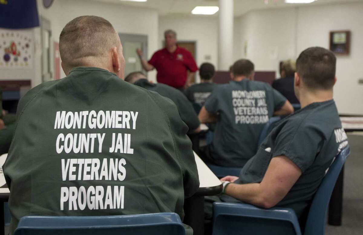 Inmates in the Montgomery County Jail's Pod 7 Veterans Program listen as Rick Pritchard, founder of the Armatus Reintegration Program, speaks, Thursday, March 20, 2019, in Conroe. Pritchard is the founder of the Armatus Reintegration Program, which aims to help integrate incarcerated veterans into society.