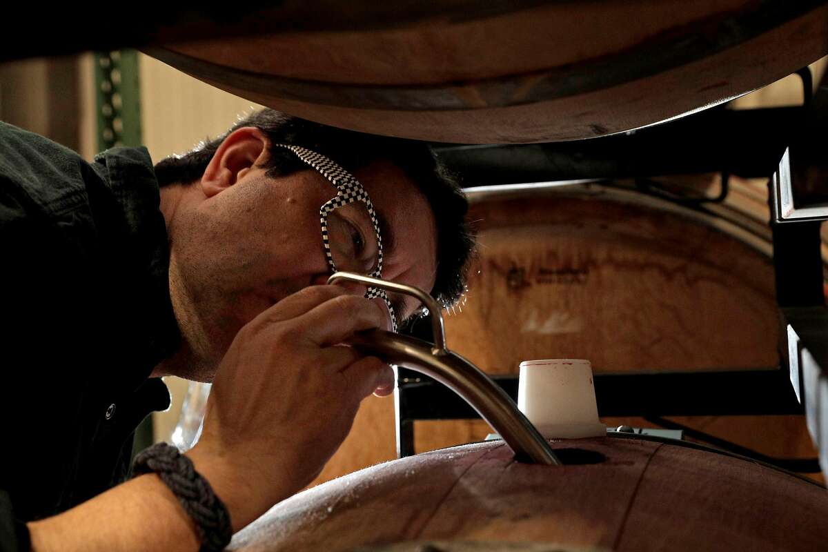 Hardy Wallace pulls a sample some of his Mourvedre wine at Sugarloaf Crush Winery in Santa Rosa, Calif., on Thursday, March 21, 2019. Hardy Wallace, winemaker/owner of Dirty & Rowdy Family Wines had a series of hardships strike him in 2017: a virus left him without sight for almost a month; wildfires devastated wine country; and most tragically, his brother in law died in a car accident while en route to come help with the wine harvest. The wine Wallace made in 2017 turned out to be problematic, but instead of throwing it down the drain he decided to embrace it.