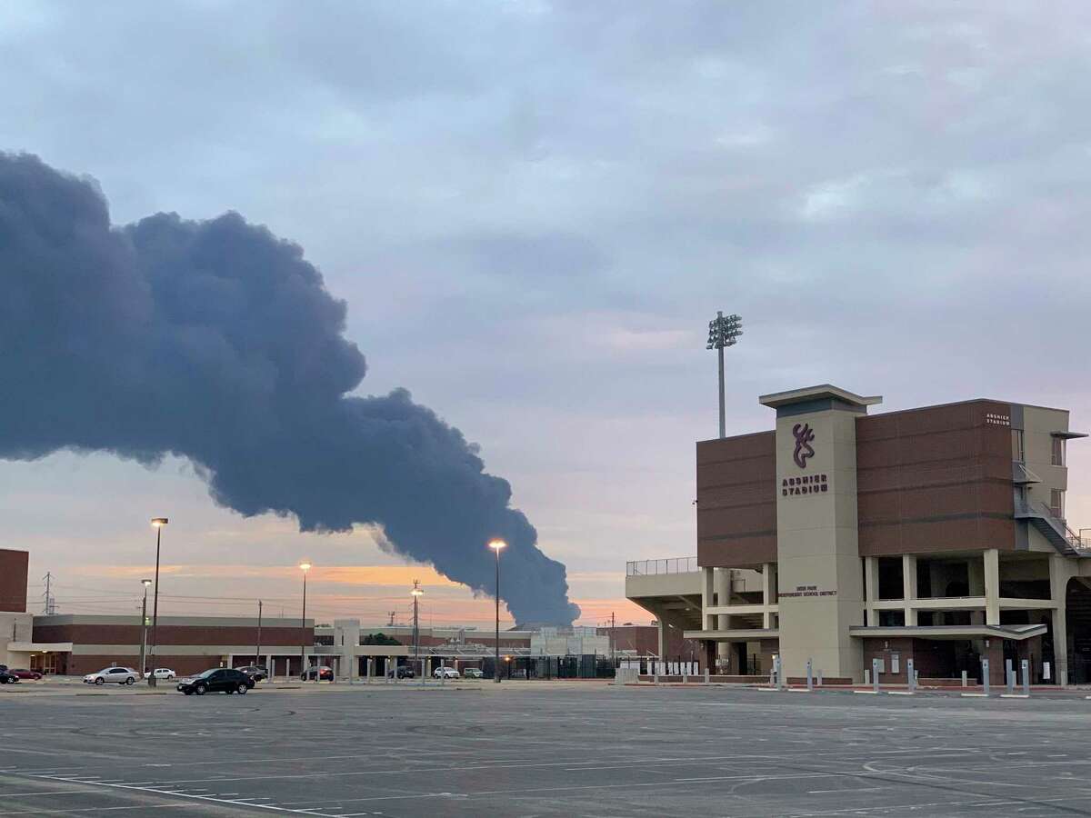 In this Tuesday, March 19, 2019 photo, shows smoke rising from a fire at the Intercontinental Terminals Company near the Deer Park School District's Abshire Stadium in Deer Park, Texas. Officials have lifted an order to remain indoors after several readings showed that the air quality had improved near a scorched petrochemical storage facility in suburban Houston. City officials in Deer Park lifted the order Thursday and reopened roads around the Intercontinental Terminals Company. But residents living near ITC say they're skeptical of what public officials are telling them. (Jeffrey Fountain via AP)