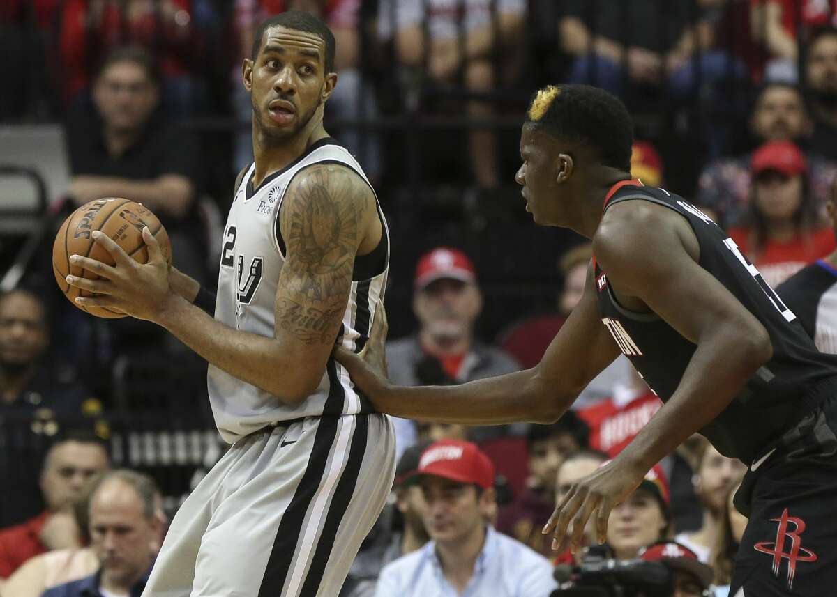 San Antonio Spurs center LaMarcus Aldridge (12) is defensed by Houston Rockets center Clint Capela (15) during the second quarter of the NBA game at Toyota Center on Friday, March 22, 2019, in Houston.