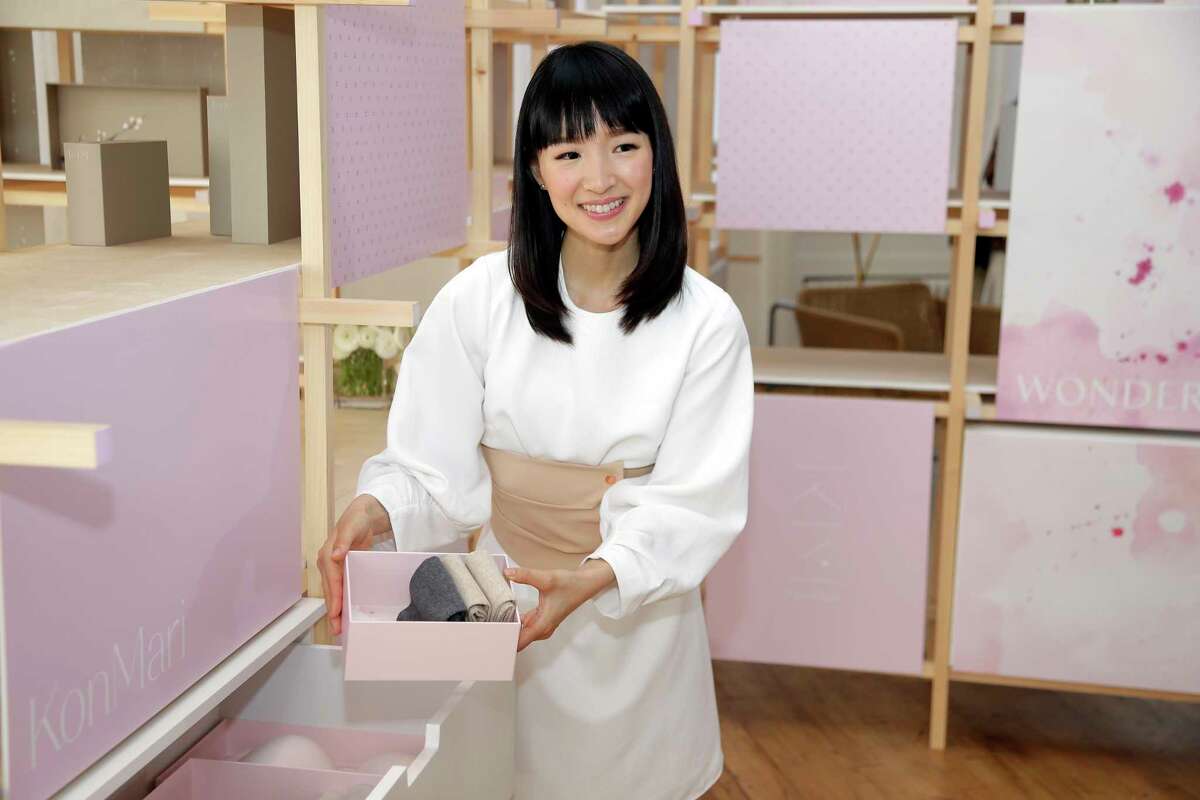 FILE- In this July 11, 2018, file photo, Japanese organizational expert Marie Kondo introduces her new line of storage boxes during a media event in New York. Kondo is sparking joy among shoppers feeling the urge to clean out their homes. But once you master the Japanese organizing expert?s novel approach to de-cluttering, what do you do with all the stuff you don?t want? (AP Photo/Seth Wenig, File)