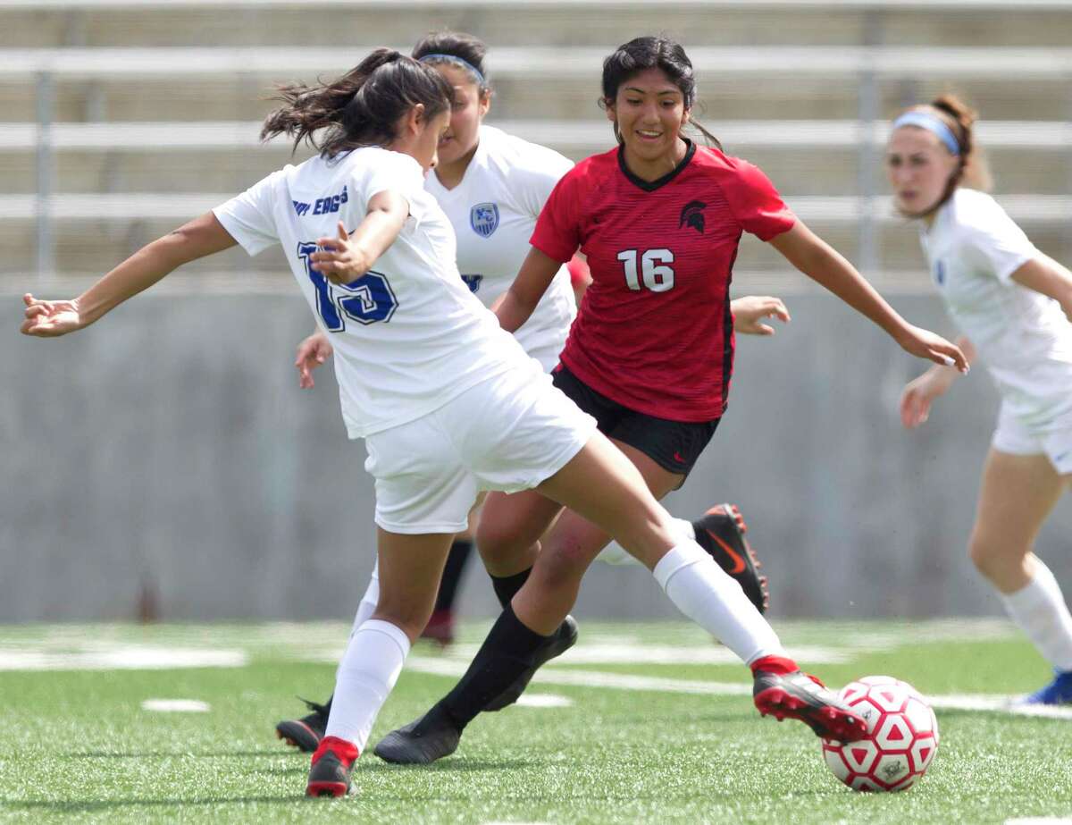 New Caney defender Kathya Leija (15) looks to control the ball in front of Porter midfielder Jasmine Marquez (16) during the first period of a District 20-5A high school girls soccer match at Texan Drive Stadium, Saturday, March 23, 2019, in New Caney.