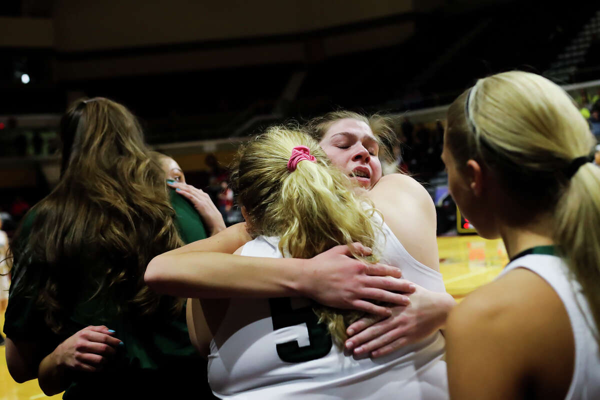 Freeland's Alyssa Argyle hugs teammates after the Falcons' 58-77 state finals loss to Detroit Edison on Saturday, March 23, 2019 at the Van Noord Arena in Grand Rapids. (Katy Kildee/kkildee@mdn.net)